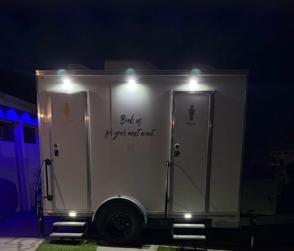 The Lavatory Lounge luxury restroom trailer illuminated at a wedding in Rancho Cucamonga, California